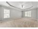 Spacious bedroom features neutral carpeting, two windows offering natural light, and a modern ceiling fan at 1999 Barrett Knoll Nw Cir, Kennesaw, GA 30152