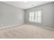 Neutral bedroom featuring a window for natural light and plush carpeting at 1999 Barrett Knoll Nw Cir, Kennesaw, GA 30152