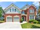 Charming brick home featuring a two-car garage, manicured lawn, and inviting curb appeal at 1999 Barrett Knoll Nw Cir, Kennesaw, GA 30152