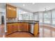 Open kitchen with wood floors, stainless steel dishwasher, and natural light at 1999 Barrett Knoll Nw Cir, Kennesaw, GA 30152