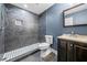 Modern bathroom features a tile shower and a dark vanity with a countertop sink at 3865 Rifflepool Ct, Douglasville, GA 30135