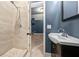 Bathroom with a tile shower with glass doors, a sink and door leading to bedroom at 3865 Rifflepool Ct, Douglasville, GA 30135