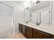 Bathroom featuring a dual sink vanity with white countertop and dark wood cabinets, adjacent to bedroom at 3865 Rifflepool Ct, Douglasville, GA 30135