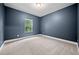 Cozy carpeted bedroom features a window with a view and neutral-toned walls at 3865 Rifflepool Ct, Douglasville, GA 30135