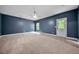 Spacious carpeted bedroom with a ceiling fan, a door to the outside, and natural light at 3865 Rifflepool Ct, Douglasville, GA 30135