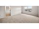 Bedroom showcasing neutral carpet, a bright window, and access to the en-suite bathroom, for privacy at 3865 Rifflepool Ct, Douglasville, GA 30135