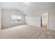 A spacious bedroom with vaulted ceilings, plush carpeting, and a bright window with neighborhood views at 3865 Rifflepool Ct, Douglasville, GA 30135