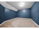 Comfortable carpeted bedroom with a large window and a calming blue wall at 3865 Rifflepool Ct, Douglasville, GA 30135