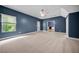 Spacious carpeted bedroom with a ceiling fan, a window with natural light, and exterior access at 3865 Rifflepool Ct, Douglasville, GA 30135