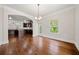 Dining room showcases wood floors, modern light fixture and a view to the kitchen at 3865 Rifflepool Ct, Douglasville, GA 30135