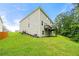 Back exterior featuring a wooden deck and large grassy area at 3865 Rifflepool Ct, Douglasville, GA 30135