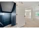 Hallway with natural light leads to the living room with large windows and plush carpet at 3865 Rifflepool Ct, Douglasville, GA 30135