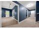 Hallway with access to multiple rooms offers neutral carpeting and a calming paint at 3865 Rifflepool Ct, Douglasville, GA 30135