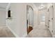 Hallway with neutral paint, archway to the kitchen, and natural light creating an inviting and spacious feel at 3865 Rifflepool Ct, Douglasville, GA 30135
