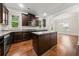 Modern kitchen with dark wood cabinets, granite countertops, stainless steel appliances, and hardwood flooring at 3865 Rifflepool Ct, Douglasville, GA 30135
