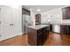 Gourmet kitchen with stainless steel appliances, island, granite counters, and wood floors at 3865 Rifflepool Ct, Douglasville, GA 30135