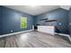 Charming kitchenette boasts modern appliances, floating shelves, and wood-look flooring at 3865 Rifflepool Ct, Douglasville, GA 30135