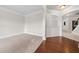 Open-concept living area with hardwood floors, a decorative archway, and neutral paint providing a modern space at 3865 Rifflepool Ct, Douglasville, GA 30135