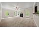 Large carpeted living room with a fireplace and a view of an outdoor balcony from an open floor plan concept at 3865 Rifflepool Ct, Douglasville, GA 30135