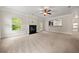 Spacious living room with a fireplace, exterior access, and a view of the kitchen from a breakfast bar at 3865 Rifflepool Ct, Douglasville, GA 30135