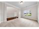 Spacious carpeted room showcasing large windows, an archway and a neutral color scheme for a bright and inviting space at 3865 Rifflepool Ct, Douglasville, GA 30135