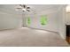 Large main bedroom with carpet, tray ceiling, and natural light from two windows at 3865 Rifflepool Ct, Douglasville, GA 30135