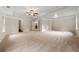 Expansive main bedroom showcasing plush carpet, tray ceilings and multiple doorways at 3865 Rifflepool Ct, Douglasville, GA 30135