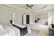 Bright main bedroom features tray ceilings, ensuite bathroom access, and staircase to the second floor at 4808 Albany Way, Atlanta, GA 30331