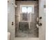 Bathroom featuring tiled shower with glass doors and modern fixtures at 537 Raven Springs Trl, Stone Mountain, GA 30087