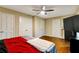 Bedroom featuring hardwood floors, a ceiling fan, and neutral walls at 537 Raven Springs Trl, Stone Mountain, GA 30087