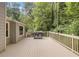 Deck overlooking a wooded area featuring wooden rails and a BBQ grill at 537 Raven Springs Trl, Stone Mountain, GA 30087