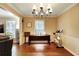 Charming dining area with hardwood floors, a chandelier, and lots of natural light, ideal for Gathering gatherings at 537 Raven Springs Trl, Stone Mountain, GA 30087