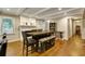 The open dining room is complimented by a stone fireplace and adjacent kitchen at 537 Raven Springs Trl, Stone Mountain, GA 30087