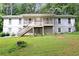 Charming two-story home featuring a covered front porch, a well-maintained lawn, and mature trees at 537 Raven Springs Trl, Stone Mountain, GA 30087