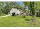 The exterior view of a two-story home with a large front yard and lots of trees at 537 Raven Springs Trl, Stone Mountain, GA 30087