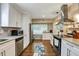 Bright kitchen boasts stainless steel appliances, granite counters, and ample storage space, perfect for culinary enthusiasts at 537 Raven Springs Trl, Stone Mountain, GA 30087