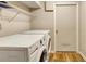 Bright laundry room featuring a washer, a dryer, and an overhead shelf at 537 Raven Springs Trl, Stone Mountain, GA 30087