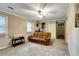 Spacious living room featuring neutral walls, carpeting and a comfortable couch at 537 Raven Springs Trl, Stone Mountain, GA 30087