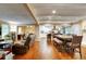 Spacious living room flows into dining area with modern kitchen, showcasing an open floor plan and hardwood flooring at 537 Raven Springs Trl, Stone Mountain, GA 30087