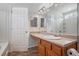 Bathroom boasts a large mirror, tile floor, and wood cabinets at 926 Hawthorn Ln, Grayson, GA 30017