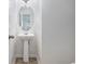 Bright bathroom featuring pedestal sink, decorative mirror and chrome hardware at 926 Hawthorn Ln, Grayson, GA 30017
