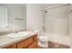Bathroom with tub and shower combo, neutral floors, and a wood cabinet at 926 Hawthorn Ln, Grayson, GA 30017