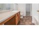 Bathroom features a neutral countertop, brown cabinets, and tile floors at 926 Hawthorn Ln, Grayson, GA 30017