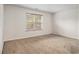Bright and airy bedroom with plush carpeting and a large window for natural light at 926 Hawthorn Ln, Grayson, GA 30017