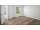 Bedroom features a window with blinds and neutral carpet at 926 Hawthorn Ln, Grayson, GA 30017