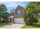 Two story brick home with an attached garage and neatly manicured front lawn at 926 Hawthorn Ln, Grayson, GA 30017