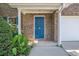 Close up of home's front door with brick exterior and neatly trimmed plants at 926 Hawthorn Ln, Grayson, GA 30017
