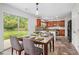 Eat-in kitchen featuring cherry cabinets, tile backsplash, and stainless steel appliances at 926 Hawthorn Ln, Grayson, GA 30017