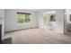 Carpeted living room showcasing an open floor plan with tile kitchen view at 926 Hawthorn Ln, Grayson, GA 30017