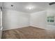 Empty room with carpeted floor and large window bringing in ample light at 926 Hawthorn Ln, Grayson, GA 30017